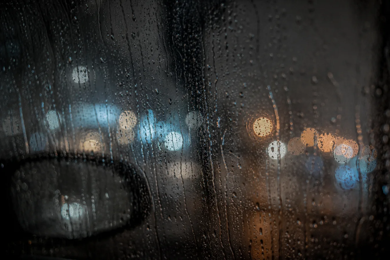 Rain on a car window at night
