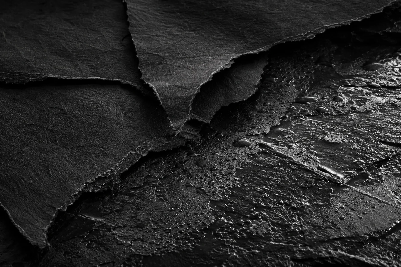 Torn slate over a wet beaded surface